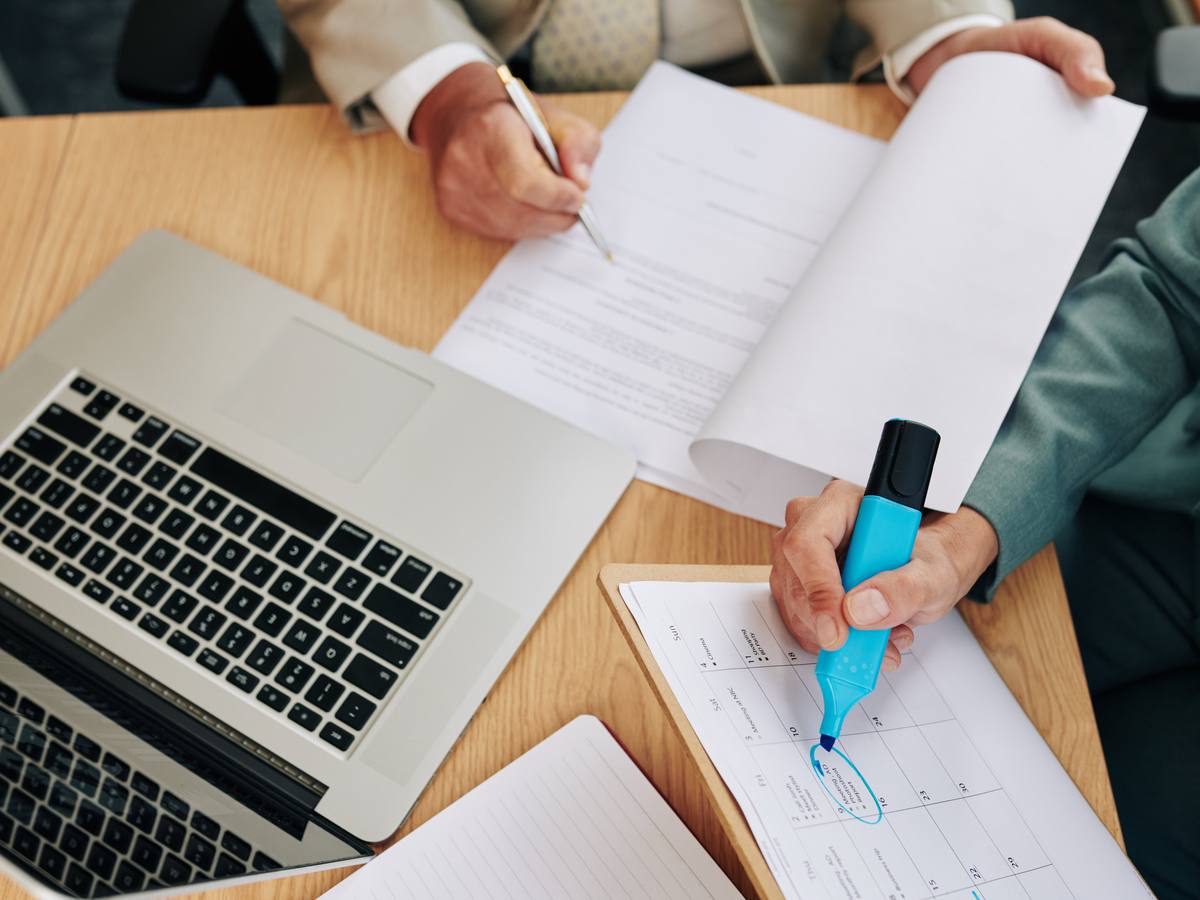 Paperwork and documentation being handled at a desk