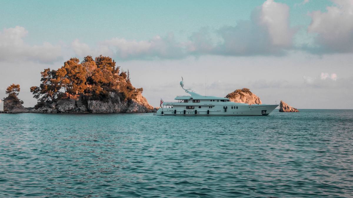 A yacht anchored beside a rocky islet in the Ionian
