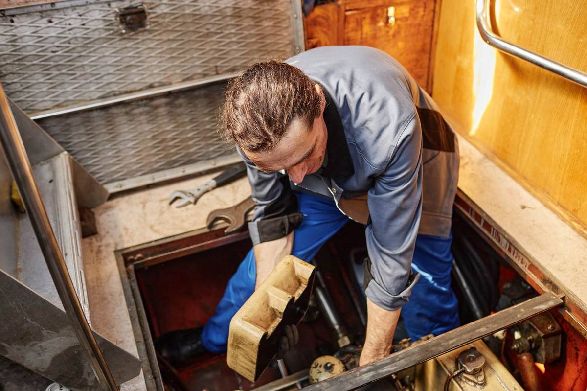 A technician inspecting a yacht engine room